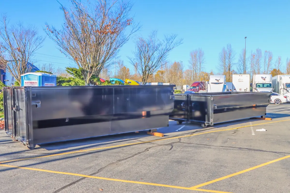 Professional dumpster rental service with roll-off container on residential driveway in Atlanta